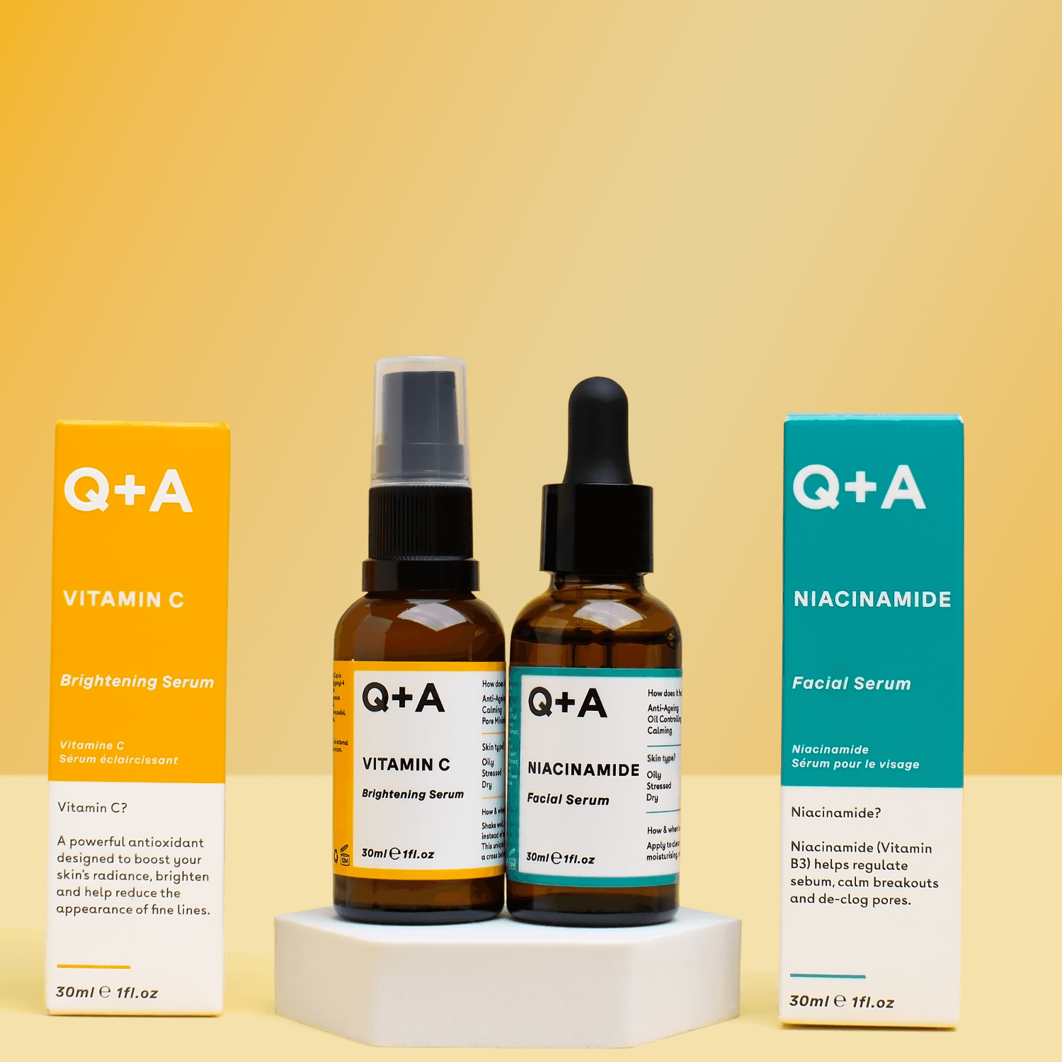 Q+A vitamin C and niacinamide skincare arranged on a white plinth against yellow